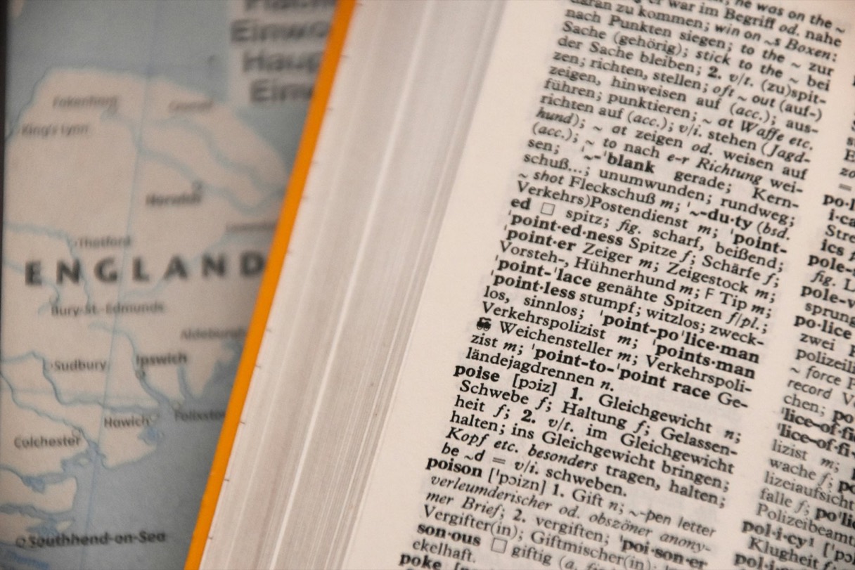 An open dictionary showing rows of printed word definitions