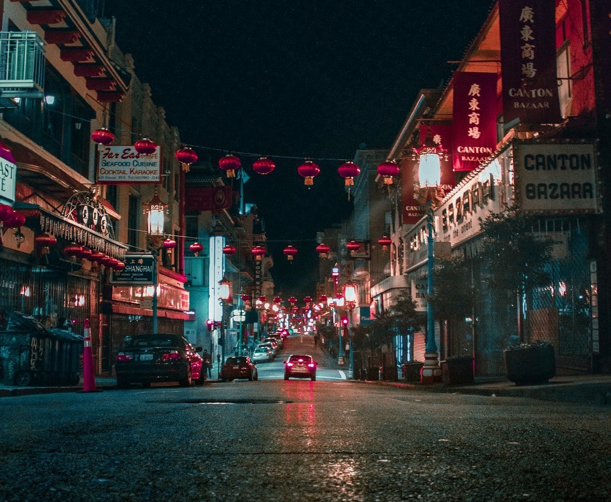 A Chinese-American storefront lit up at night, signage in Chinese and English