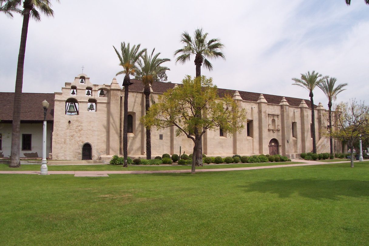 The south wall and bell campanario of Mission San Gabriel Arcángel.